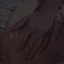 a close up of a person 's hand with a ring on their finger