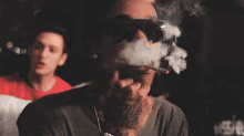 a man with a tattoo on his neck is smoking