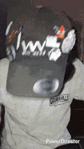 a person wearing a shirt that says grand & hills on it