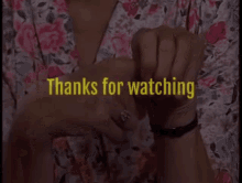 a woman 's hands are shown with the words thanks for watching behind them
