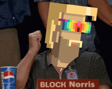a man sitting at a table with a name tag that says block norris