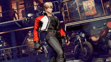 a man in a red and white jacket is standing in a room with motorcycles .