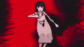a girl in a pink dress is standing in front of a skull with blood coming out of it .