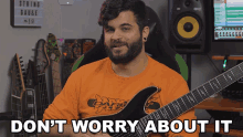 a man holding a guitar with the words " don t worry about it " below him