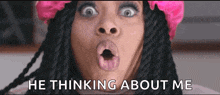 a woman with dreadlocks and a pink flower in her hair says he thinking about me .