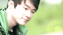 a close up of a man 's face with a green background