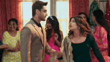 a man and woman are standing next to each other in a room .