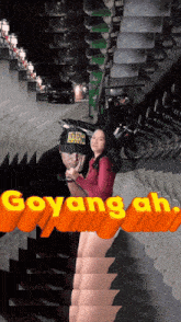 a man and a woman are posing for a picture with the words goyang ah above them