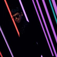 a man wearing sunglasses and a black jacket with stars on it