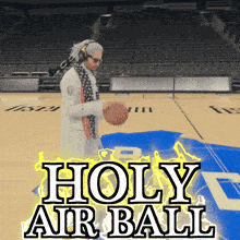 a man is holding a basketball on a basketball court with the words holy air ball above him