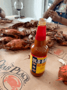 a bottle of old bay hot sauce sitting on a table