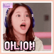 a woman wearing headphones is making a surprised face and says oh lion !
