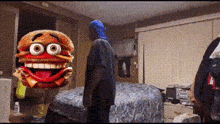a person in a blue hoodie is standing next to a cartoon hamburger with big eyes