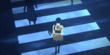 a girl in a school uniform is walking across a crosswalk at night