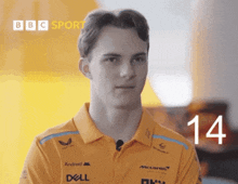 a man wearing an orange shirt with the number 14 on the front