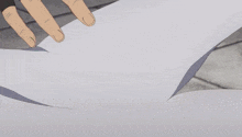 a person with a black glove on their hand