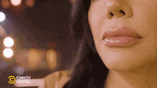a close up of a woman 's lips with the comedy central logo visible