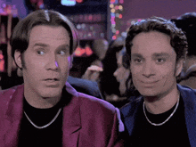 two men are looking at each other in a bar