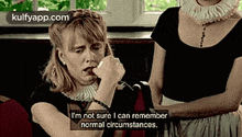 a woman is sitting on a couch with a caption that says i 'm not sure i can remember normal circumstances
