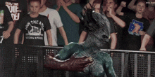 a man wearing a shirt that says viking rider stands in front of a crowd