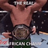 a man without a shirt is holding a ufc belt .