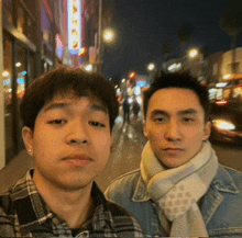 two young men are posing for a picture in front of a sign that says ' chinese restaurant ' on it