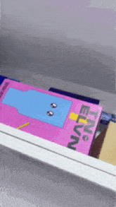 a pink box with a blue face on it that says tiny evian