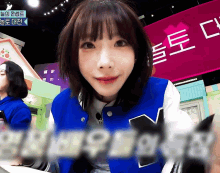 a girl wearing a blue jacket with the letter m on the front