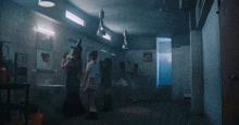 a group of people standing in a dark room