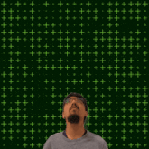a man stands in front of a green background with stars and the number 31