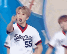 a man wearing a jersey that says golden child on it
