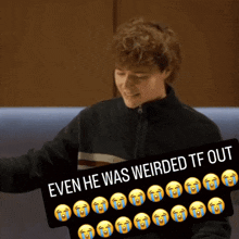 a young man holding a sign that says " even he was weirded tf out "