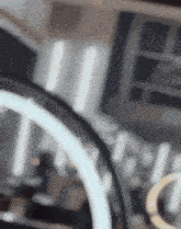 a blurred image of a steering wheel with a white ring on it