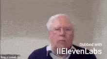 an older man with glasses is sitting in front of a wall and talking on a video call .