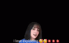 a woman is standing in front of a fireworks display and saying i love exploding