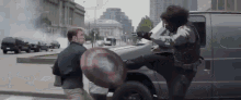 captain america and black widow are fighting in the street .