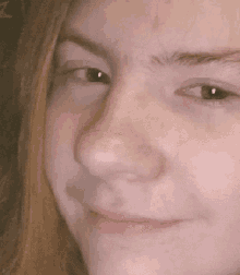 a close up of a person 's face with a smile on it .