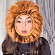 a woman is wearing a lion costume with a lion head