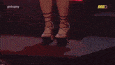 a woman 's legs are shown in a blurry photo with the word bbbo on the bottom