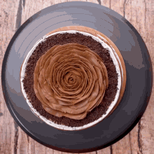 a chocolate cake with a rose on top of it