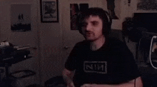 a man wearing headphones is dancing in a room .