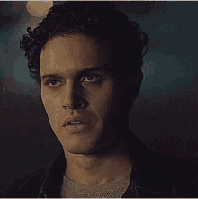 a close up of a man 's face in a dark room .