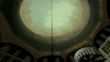 a clock tower with a dome on top of it and a clock hanging from the ceiling .