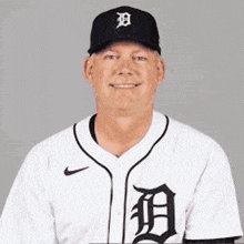 a man wearing a baseball uniform with the letter d on the front