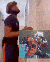 a man in a black shirt is standing next to a picture of a man in a red jacket