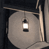 a lantern hanging from the ceiling with a white light inside