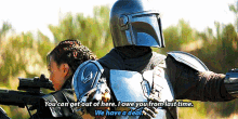 a man in a helmet is talking to a woman with a gun
