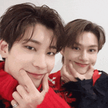 two young men are posing for a picture with their hands on their faces