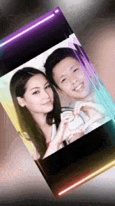 a picture of a man and a woman making a heart shape with their hands