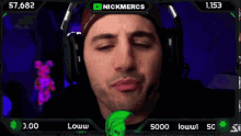 a man wearing headphones with nickmercs written on the top